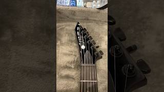 Unclasping an ESP LTD MT-I Mick Thomson Signature Electric Guitar