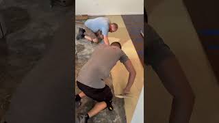 Engineered wood flooring installation. Glue down. ￼