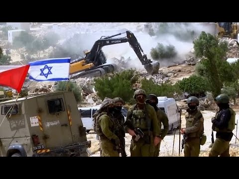 Israeli bulldozers demolish most of a West Bank Bedouin hamlet displacing dozens of Palestinians