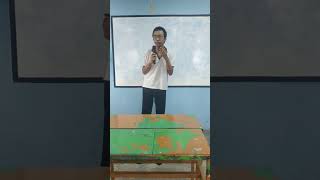 A Grade 10 student confidently presenting in the English Talent Competition.
