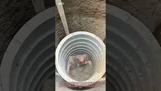 "Dramatic Pipe Sinking: Workers Dodge Danger in Precision Trench Work!"