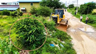 Amazing bulldozer clearing dirt and trash filling land with dump trucks