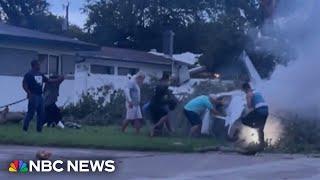 Residents rescue survivors after small plane crashes into neighborhood