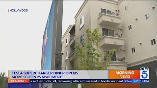 Tesla's Diner movie screen erected in front of apartment balconies