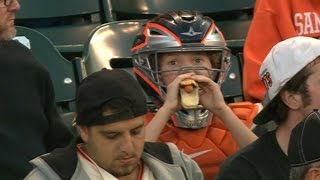 PHI@SF: Kid wears catcher's gear in the stands