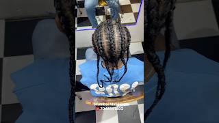 Mohawk cornrows with extensions feature tight side braids and long added hair for a bold look