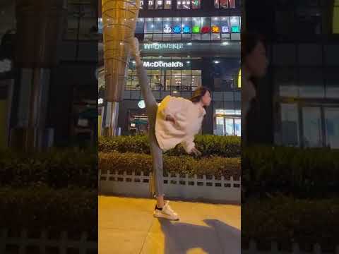 young dancer showing the perfect split in shopping center