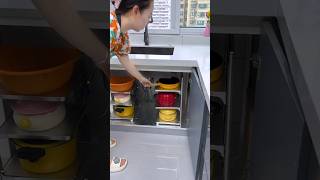 You can put a multi-layer pot rack like this in the cabinet under the kitchen sink.