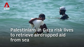 Palestinians in Gaza risk their lives to retrieve airdropped aid from the sea