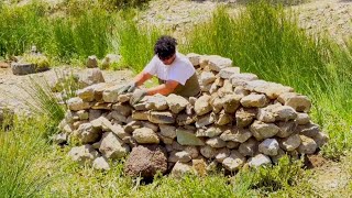 Building a warm and cozy stone shelter in the mountain. Survival skills