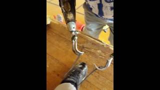 Bilateral arm Amputee tying his sons baseball shoes