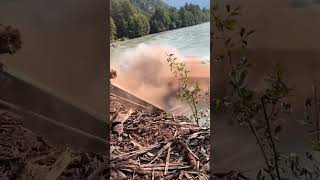 The logs are unloaded from trucks into the river and transported using the river water.