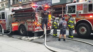 FDNY engine 65 and tower ladder 7 operating at a parking garage with multiple vehicles on fire.