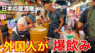 外国人観光客が新しい日本の居酒屋で爆飲みする