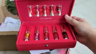 Unboxing Clarins Lip Oil Collection set with red mini bag + swatches of 6 Clarins lip oil colors