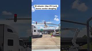 18-wheeler clips lift truck, leaves worker dangling