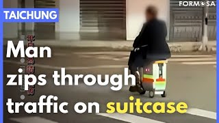 Man zips among Taichung traffic on motorized suitcase｜Taiwan News