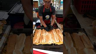 Malaysian egg toast cooked on a large griddle