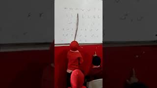 Cute student teaching Urdu alphabets.Teaching by a little kid.ا کہتا ہے اہ۔