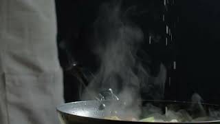 Sprinkling Rock Salt As Seasoning On A Dish Being Cooked