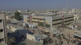 Palestinians carry aid in Gaza's Khan Younis